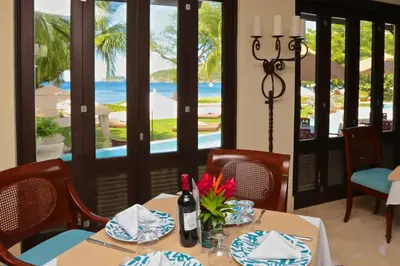 a dining room with a table with a bottle of wine at Luxurious Pacifico 2bed condo in Playa Coco in Coco