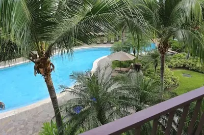 a view of a swimming pool from a balcony at Luxurious Pacifico 2bed condo in Playa Coco in Coco