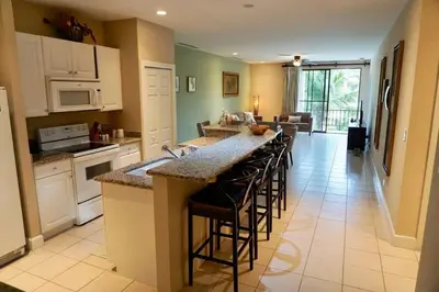 a kitchen with a large island with bar stools at Luxurious Pacifico 2bed condo in Playa Coco in Coco