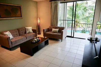 a living room with a couch and a table at Luxurious Pacifico 2bed condo in Playa Coco in Coco