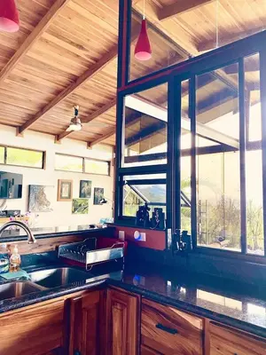 a kitchen with a sink and a window at Romantic Retreat Volcano View! River Trail! in El Castillo de la Fortuna