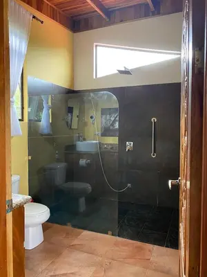 a bathroom with a shower and a toilet at Romantic Retreat Volcano View! River Trail! in El Castillo de la Fortuna