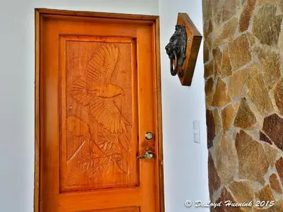 a wooden door with a bird design on it at Romantic Retreat Volcano View! River Trail! in El Castillo de la Fortuna