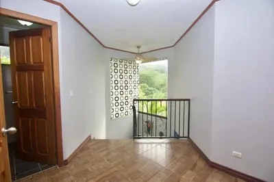 an empty hallway with a door and a window at Firefly Hilltop Retreat, Swimming Pool Volcano! in El Castillo de La Fortuna
