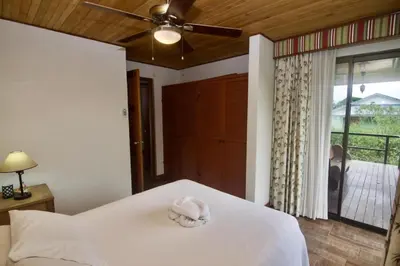 a bedroom with a bed with a white towel on it at Firefly Hilltop Retreat, Swimming Pool Volcano! in El Castillo de La Fortuna