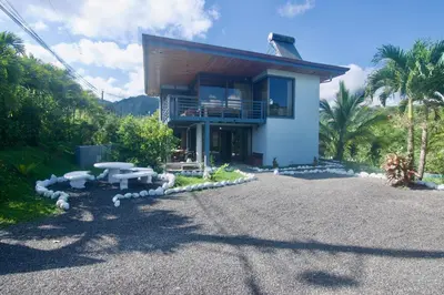 a house with a gravel driveway in front of it at Firefly Hilltop Retreat, Swimming Pool Volcano! in El Castillo de La Fortuna