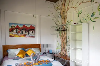 a bedroom with a bed with two swans on it at Laughing Falcon Studio in El Castillo de La Fortuna
