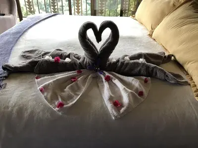 a blanket with a heart on top of a bed at Laughing Falcon Studio in El Castillo de La Fortuna