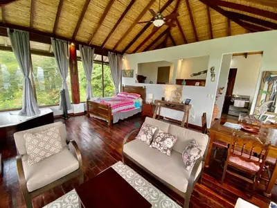 a living room with a couch and a bed at Birdsong Villa, Romantic Suite W- Jacuzzi in El Castillo de La Fortuna