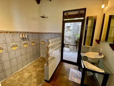 a bathroom with a shower and a sink at Arenal Birdsong, Entire Villa W- Stunning Views,! in El Castillo de La Fortuna