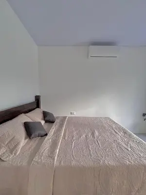 a bedroom with a large bed with two pillows on it at The Slothie's House in Tapantí