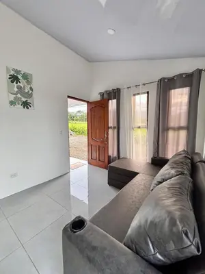 a living room with a couch in the middle at The Slothie's House in Tapantí