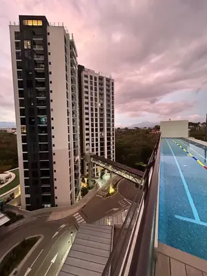 a view from the balcony of a building with a swimming pool at Cerca del Estadio Nacional Sabana Núcleo Apartamento 'Casa Bientenveo' in San José