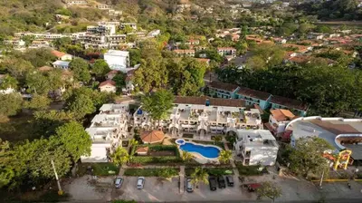 an aerial view of a house with a pool at Charming Nook Second Floor Condo with Rooftop in Coco