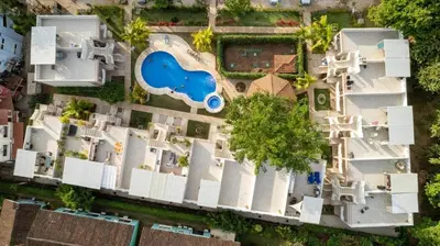 an aerial view of a house with a swimming pool at Charming Nook Second Floor Condo with Rooftop in Coco