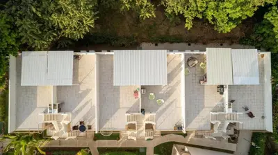 an overhead view of a building with four white billboards at Charming Nook Second Floor Condo with Rooftop in Coco