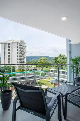 a balcony with a table and chairs on a building at Viva Jaco II in Jacó