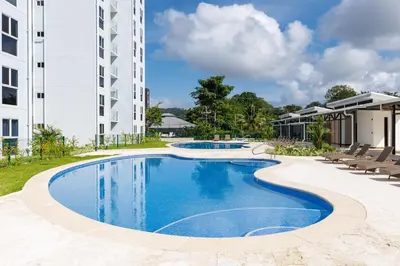 an image of a swimming pool in front of a building at Viva Jaco in Jacó