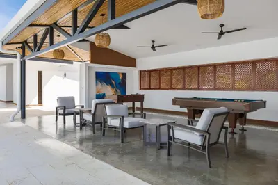 a room with a pool table and chairs at Viva Jaco in Jacó