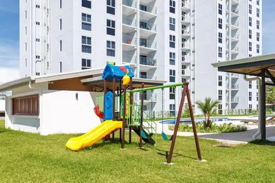 a playground in front of a apartment building at Viva Jaco in Jacó