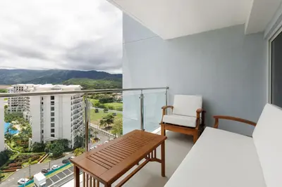 a balcony with a bench and a view of a city at Viva Jaco in Jacó