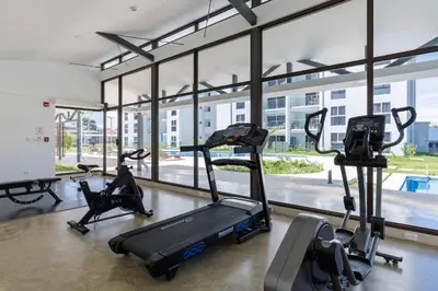 a gym with treadmills and ellipticals in a building at Viva Jaco in Jacó