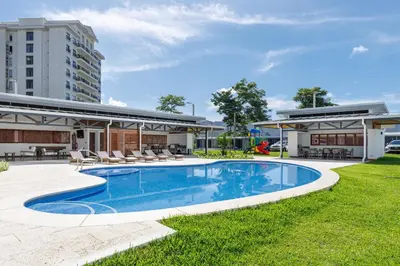 an image of a swimming pool in front of a building at Viva Jaco in Jacó