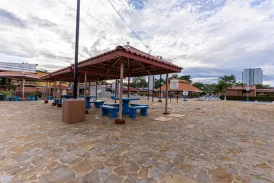 a pavilion with blue picnic tables in a pavillion at Villas Paraiso B52 in Jacó