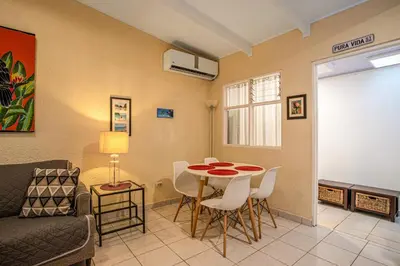 a living room with a couch and a table and chairs at Villas Paraiso B52 in Jacó