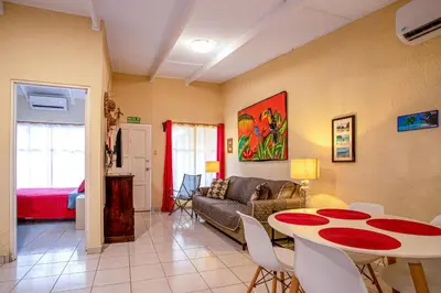 a living room with a table and a couch at Villas Paraiso B52 in Jacó