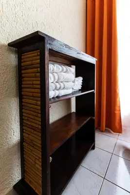 a wooden cabinet with towels in a room at Villas Paraiso B52 in Jacó