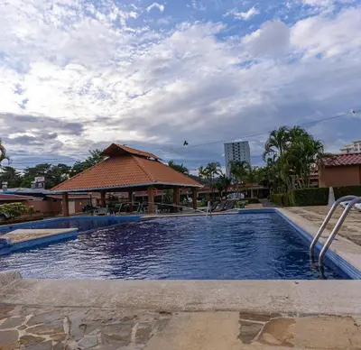 a large swimming pool in front of a building at Villas Paraiso B52 in Jacó