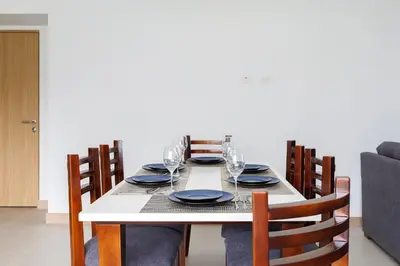 a dining room table with plates and glasses on it at Viva Jaco II in Jacó