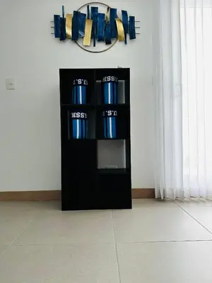 a black shelf with blue vases in a room at Viva Jaco II in Jacó