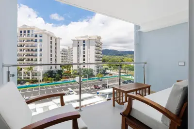 a balcony with a view of a city at Viva Jaco II in Jacó