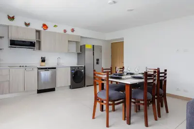 a kitchen with a table and chairs in a room at Viva Jaco II in Jacó