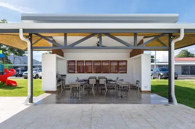 a pavilion with tables and chairs on a patio at Viva Jaco II in Jacó