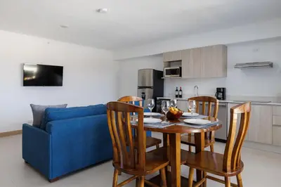 a kitchen and dining room with a table and chairs at Viva Jaco II in Jacó