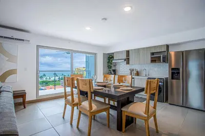 a kitchen and dining room with a table and chairs at Viva Jaco II in Jacó