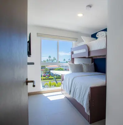 a bedroom with a bed and a large window at Viva Jaco 04 02B in Jacó