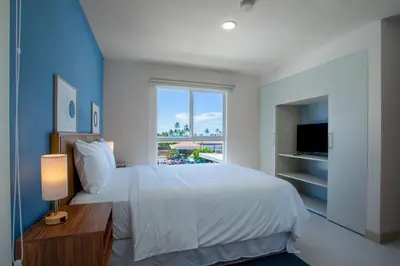 a bedroom with a white bed and a window at Viva Jaco 04 02B in Jacó