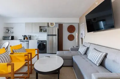a living room with a couch and a table at Viva Jaco in Jacó