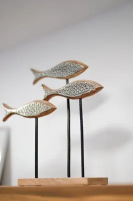 a pair of bird sculptures on a wooden stand at Blue 2BR 2BA 10 Min Beach Walk in Nosara