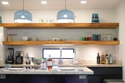 a kitchen with a counter with bottles and glasses at Blue 2BR 2BA 10 Min Beach Walk in Nosara