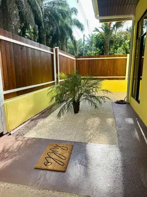 a welcome mat on the floor of a house with a fence at Casa Sol in Naranjito
