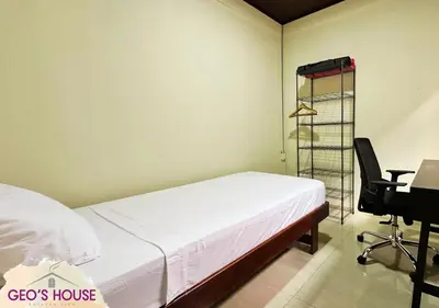 a bedroom with a bed and a desk and a chair at Geo'S House & Volcan View in Fortuna