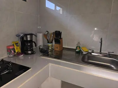 a kitchen counter top with a sink and a counter top at Apartamento Las Tecas in Quepos