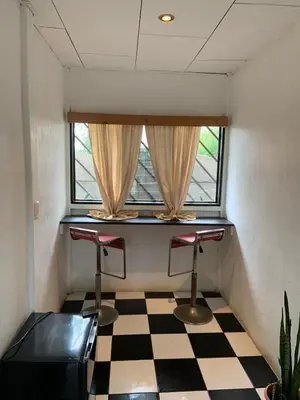 a room with two bar stools and a window at Hotel Monte del Mago in Carrillos