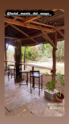a group of tables and chairs under a pavilion at Hotel Monte del Mago in Carrillos