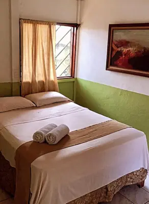 a bedroom with a bed with towels on it at Hotel Monte del Mago in Carrillos